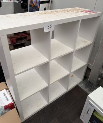 a white bookcase with a lot of shelves on it