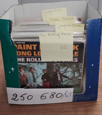 a cardboard box with a bunch of records in it