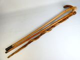 pair of wooden walking canes on a white surface