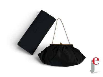 the black clutch bag is next to a black purse