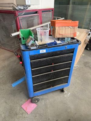 a blue workbench with tools on it in a garage