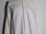 the white jacket is on a mannequin stand against a white wall
