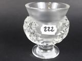 a close up of a glass cup on a black surface