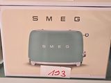 two boxes of smeg toasters on display in a store