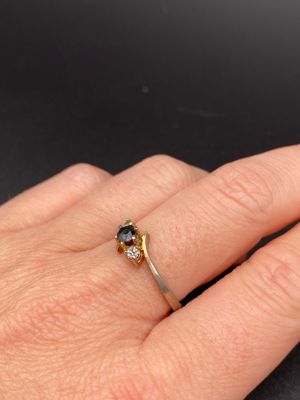 a close up of a person ' s hand with a ring on it