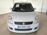a small white car that is parked in a garage