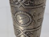 a silver cup that is sitting on a table