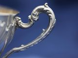 close up of a silver cup on a blue background