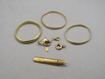 five rings and a pen sitting on a table