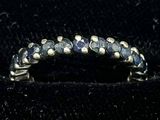 an image of a ring with blue stones on it
