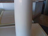 a white vase sitting on a table in a kitchen