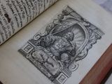 an old book with a drawing on it sitting on a table