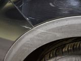 a close up view of a car ' s tire with a hole in the tire