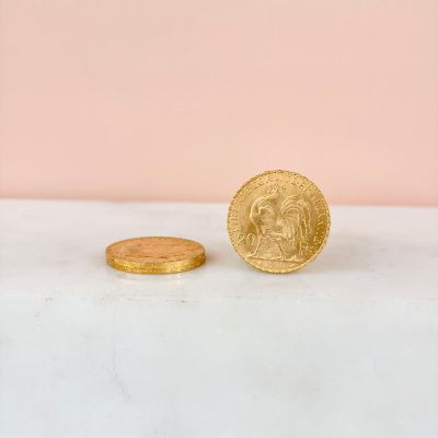 a close up of a coin sitting on top of a counter next to a coin