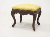 an image of a small stool with a yellow cushion on it