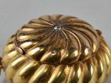 an image of a gold locke with a diamond in the center