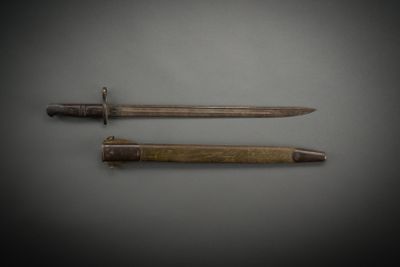 two knives are laying side by side on a gray surface