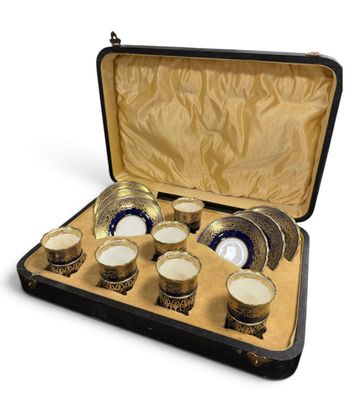 a case that has a set of cups and saucers in it