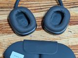 an image of a pair of headphones and a pair of eye mask on a wooden floor
