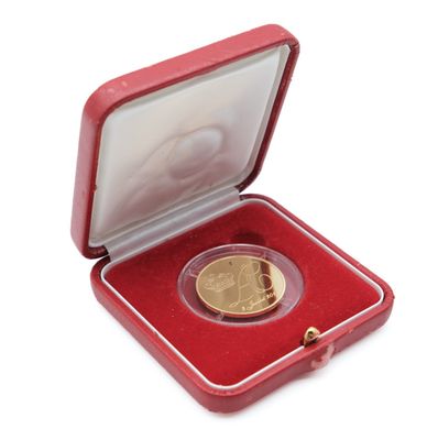 an image of a gold coin in a red case on a white background