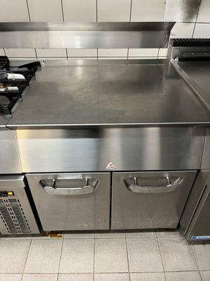 a stainless steel kitchen with a stove and oven