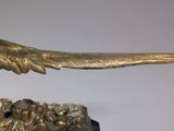a statue of a bird that is on top of a table