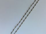 un collier en argent dont l'extrémité est ornée d'une chaîne
