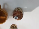a brown vase and a brown cup on a white table