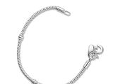 a close up of a silver bracelet on a white background
