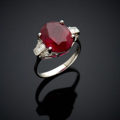 an oval ruby and diamond ring with baguets