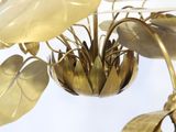 a plant that is in the middle of a gold vase