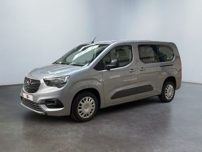 the silver van is parked in a room with a white wall