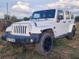 a white jeep that is parked in the grass