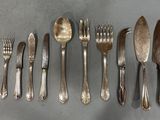 a lot of forks and spoons on the table