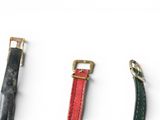 three different types of leather straps on a white surface