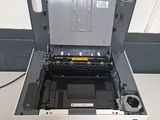 the printer is sitting on top of the table with its tray open