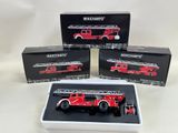 three red fire trucks are in a white box on a white surface