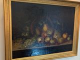 a painting hanging on the wall above a bed