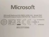 the back side of a white laptop with the microsoft logo on it