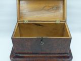 an old wooden box with a lock on top of it