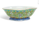 a green and blue bowl sitting on top of a white table