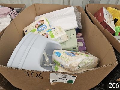 a cardboard box filled with diapers and other items