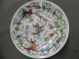 a white plate with colorful birds and flowers on it