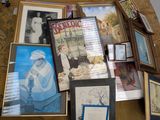 many framed pictures on the floor of a living room