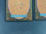 two cards with different designs on them sitting on a table