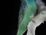 a figurine of a bird sitting on top of a flower