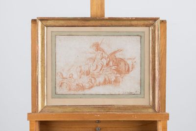 an old picture of a man riding a horse on a wooden easel