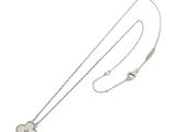 a close up of a necklace with a heart on a chain