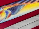 a painting of a fish on a tie on a red surface