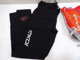 nike leggings and a pair of running shoes are on a table